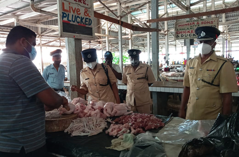 Police Commander, Superintendent Jairam Ramlakhan and team interacting with a butcher at the Corriverton Market.