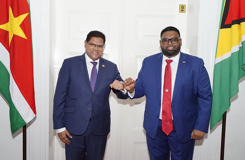 President, Dr. Irfaan Ali shares a light moment with Suriname’s President Chandrikapersad Santokhi. President Ali is in neighbouring Suriname on an official
State visit (Office of the President photo)