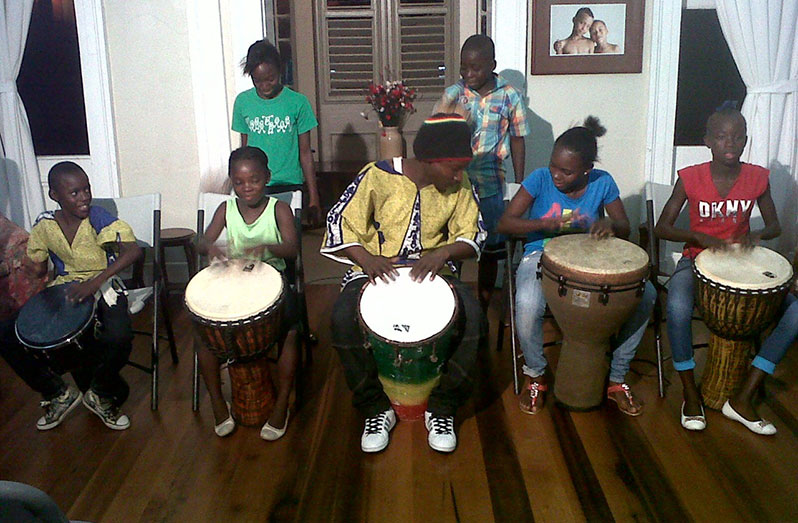 Marlon “Chucky” Adams and some of the children he taught drumming