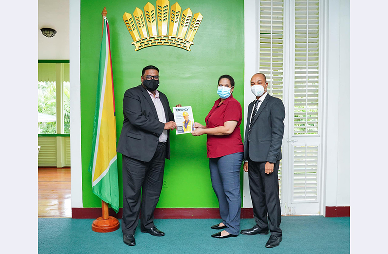 Editor-in-Chief, Gwen Evelyn, presents a copy of the new publication, ‘Energy’ to President, Dr. Irfaan Ali. At right is Managing Partner of Energy Guyana Inc., Chris Chapwanya (Office of the President photo)