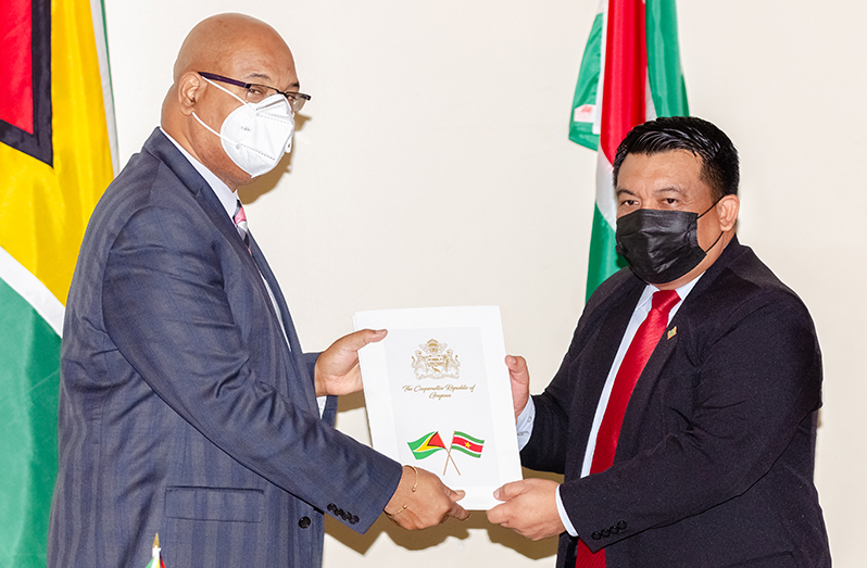 Minister of Public Works, Bishop Juan Edghill, and Suriname’s Minister of Communication, Transport and Tourism, Mr. Albert Jubithana hold the newly sanctioned open-skies air service agreement (Delano Williams photo)