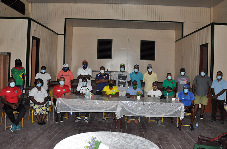 GFF president Wayne Forde (seated 3rd right) takes time out for a photo following the meeting with members of the Kwakwani Community last Sunday night at the Workers Club.