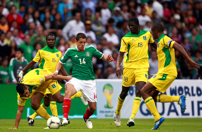 FLASHBACK! Mexico’s Javier ‘Chicharito’ Hernandez (#14) swarmed by Guyanese players at the BBVA Compass Stadium in Houston, Texas. That game, in 2012, should’ve been played at the Guyana National Stadium.