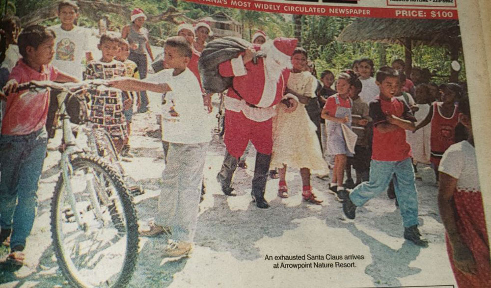 An exhausted Santa Claus arrives at Arrowpoint bearing gifts for children of Amerindian communities (December 23, 2003)