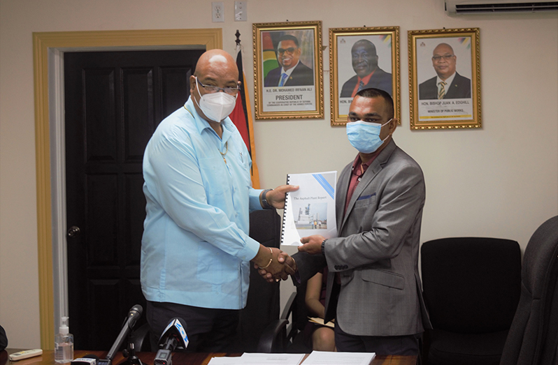 Chairman of the investigative team, Chateram Ramdihal (right) presents the findings to Minister of Public Works, Juan Edghill
