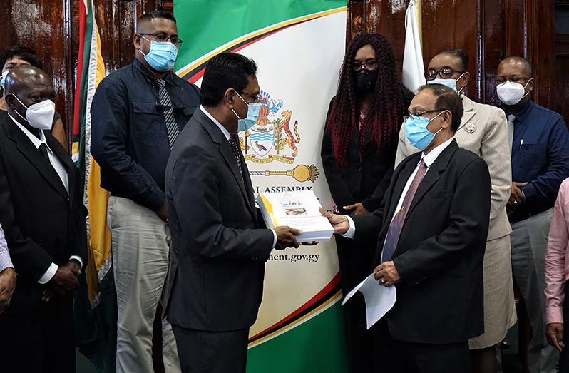 The Auditor General, Deodat Sharma (right) handing over his 2019 report to the Speaker of the National Assembly, Manzoor Nadi