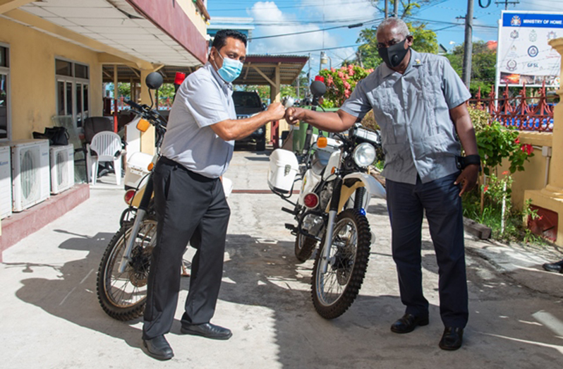 Minister of Home Affairs, Robeson Benn, receives donation from Sean Ramrattan, owner of RRT Enterprise