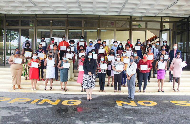 Minister of Human Services and Social Security, Dr Vindhya Persaud (front centre), with those who graduated and other officials