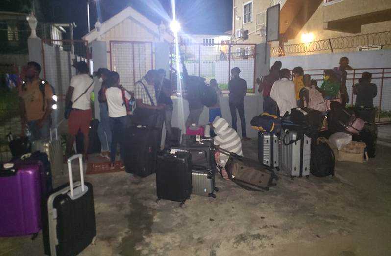 The Haitians outside of a City hotel on Wednesday night after being released from protective custody
