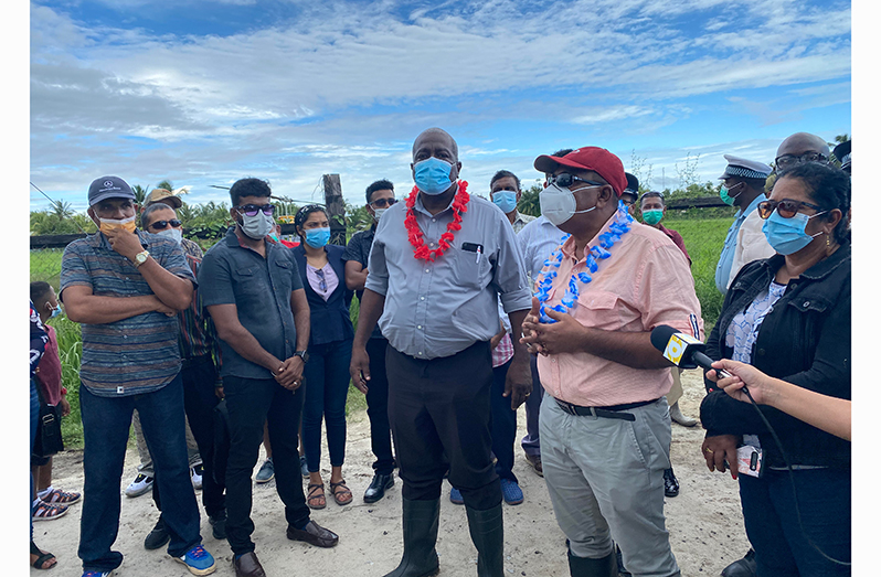 Prime Minister Mark Phillips and Minister of Agriculture Zulfikar Mutapha  listen to concerns of residents. Also pictured (right) is Regional Chairperson, Vilma De Silva