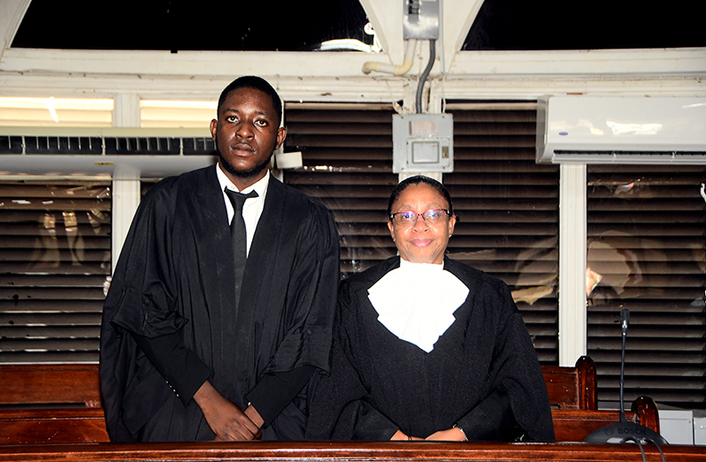 New attorney Jamaal Duff alongside Chief Justice (ag), Roxane George SC after his admission to the local bar