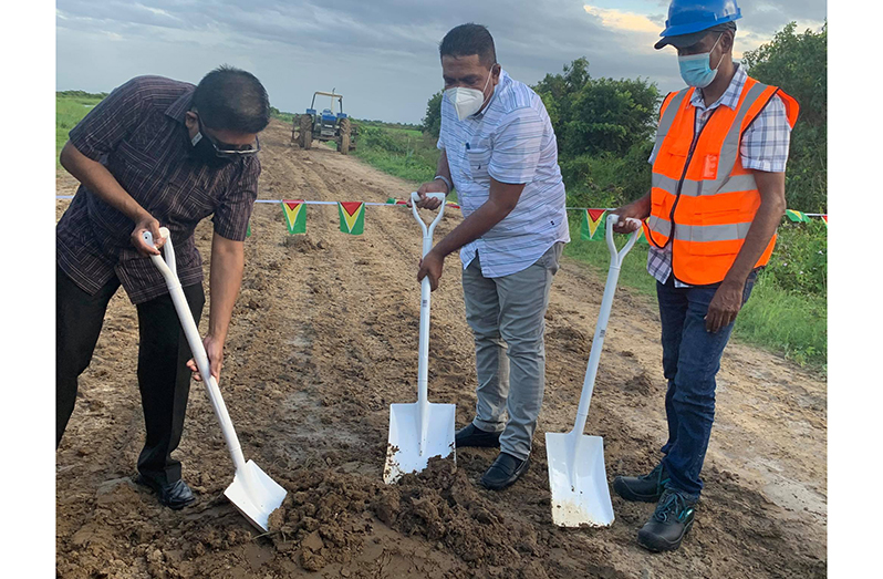 Flashback: Minister of Agriculture, Zulfikar Mustapha (centre); Senior Minister within the Office of the President with responsibility for Finance, Dr. Ashni Singh (left) and the contractor, Romell Jagroop (right), turn the sod for construction of the farm-to-market road at Onverwagt, West Coast Berbice