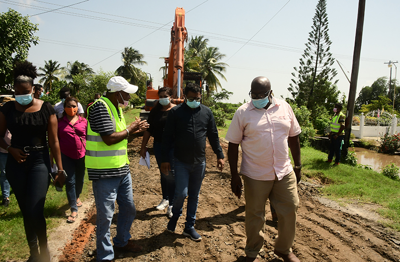 Minister within the Ministry of Public Works, Deodat Indar discussing the status of
ongoing works at East Street with contractor Mohammed Ramzan Ali Khan