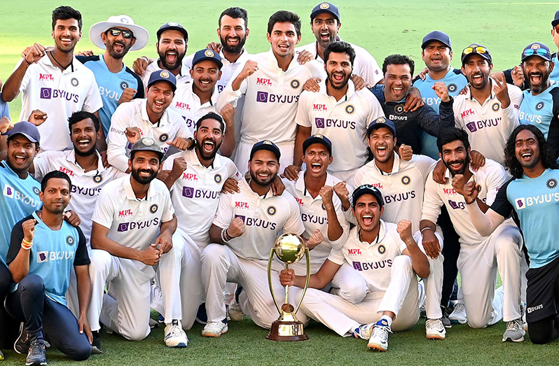 Indian players pose with the winning Border-Gavaskar trophy after defeating Australia by three wickets on the final day of the fourth cricket Test match at the Gabba, Brisbane. (PTI)
