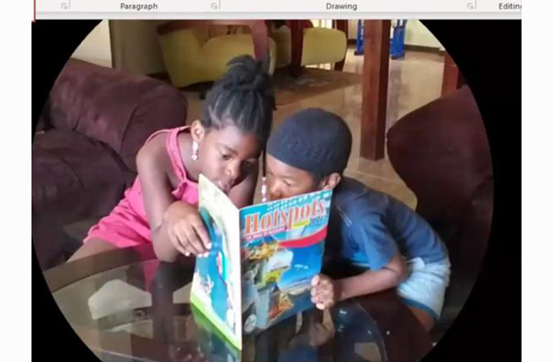 Two youngsters, immersing themselves in the good reads contained in the Ministry of Tourism’s Hotspot Magazine
