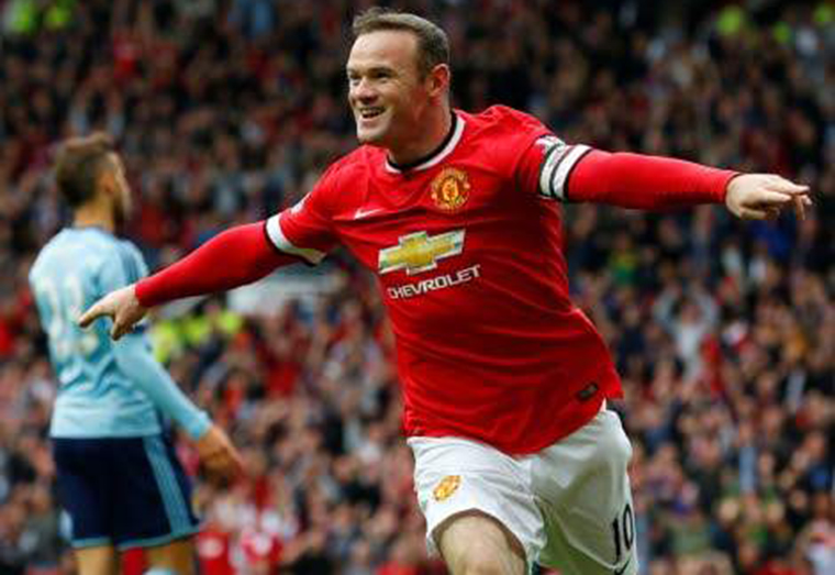 In this file photo taken on September 27, 2014, Manchester United's English striker Wayne Rooney celebrates scoring the opening goal during the English Premier League match against West Ham United at Old Trafford in Manchester. (Photo: AFP)
