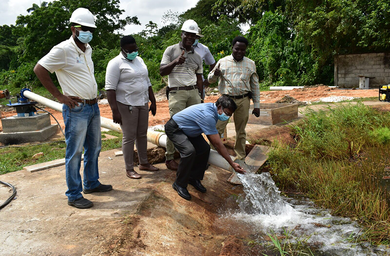 GWI Chief Executive Officer, Shaik Baksh, samples the water that was being pump-tested (DPI photo