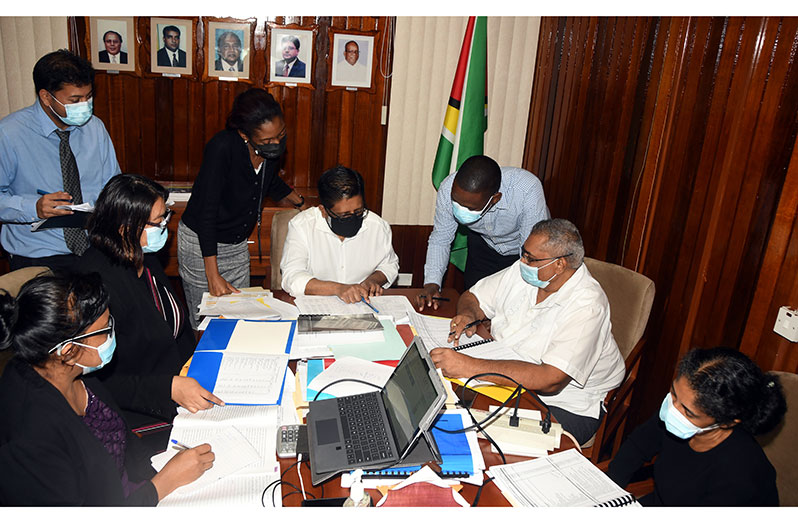 Senior Minister in the Office of the President with responsibility for Finance, Dr. Ashni Singh and his team reviewing Budget 2021 ahead of its presentation in the National Assembly today (Adrian Narine photo)