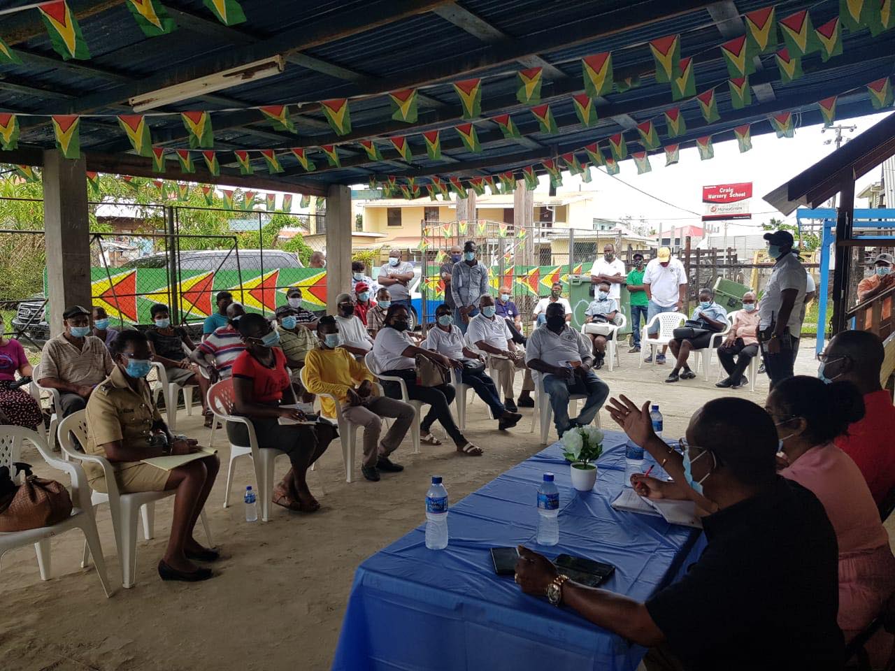 Deputy Commissioner (ag), Clifton Hicken, at the head table with other senior officers at the Caledonia/Good Success NDC during the meeting with residents