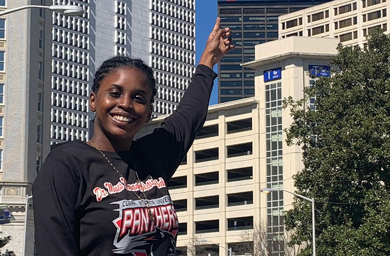 Nicola Ramdyhan points to her name boldly displayed on a building in Atlanta, in recognition for outstanding achievement in tennis in the the State of Georgia.