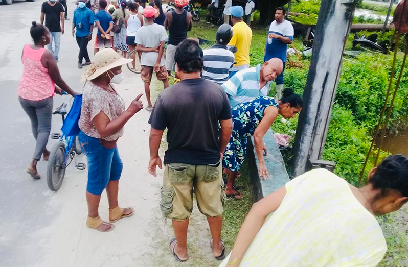 Curious residents looking at the spot where Chitramjan Das was discovered