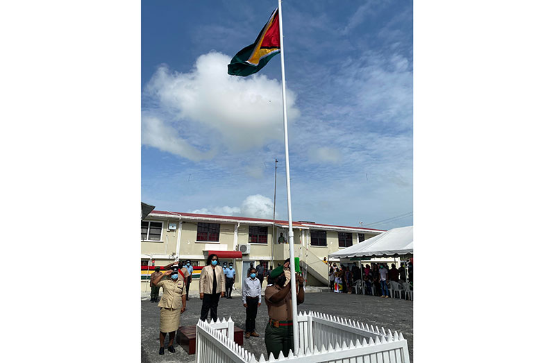 Regional Commander Crystal Robinson, Chairperson Vilma De Silva, Vice-Chairman Humace Oodit and Head of the Anna Regina Fire Station, Suresh Persaud stand at attention as the Golden Arrowhead is being hoisted
