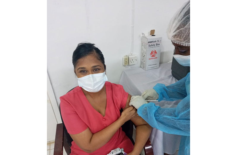 Sister in charge of Suddie Public Hospital, Deokie Lall, receiving the first dose of the COVID-19 vaccine