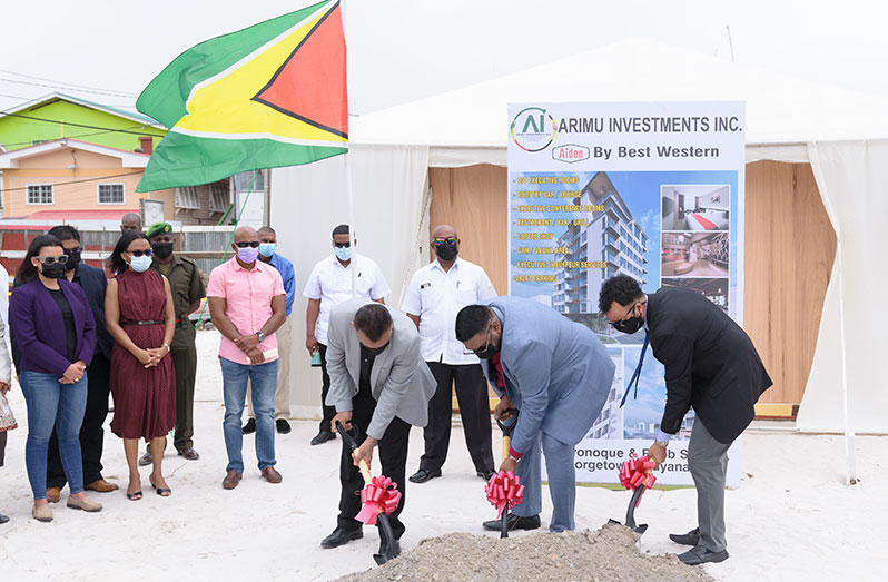 President, Dr. Irfaan Ali (centre); CEO of Go-Invest, Dr. Peter Ramsaroop (left) and Co-Director of Arimu Investments Inc., Lorenzo Alphonso, do the ceremonial turning of the sod to initiate  construction of the US$15M Aiden by Best Western Hotel at the corner of Robb and Oronoque Streets, Georgetown (Delano Williams photo)