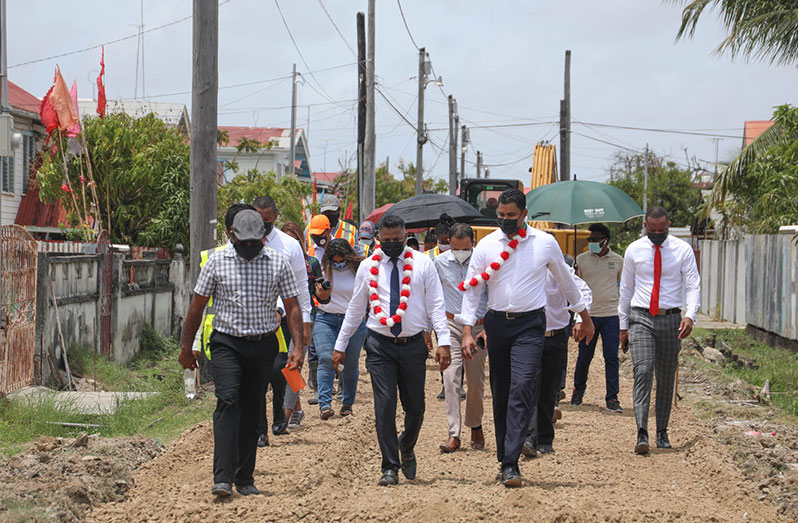 Minister within the Ministry of Public Works Deodat Indar; Minister of Culture, Youth and Sport, Charles Ramson, and representatives of the NDC assessing some of the ongoing infrastructural works