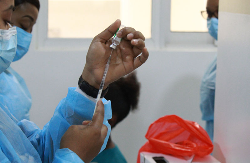 A nurse at the National Infectious Diseases Hospital at Liliendaal, Greater Georgetown, preparing to administer a dose of the Oxford-Astrazeneca vaccine to a local healthcare worker on Thursday (Vishani Ragobeer photo)