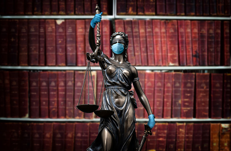 Lady Justice, in Personal Protective Equipment (PPE) (Credits: Getty Images)