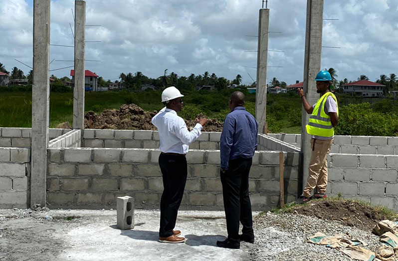 GFF President Wayne Forde (white shirt) inspecting works at one of the facilities on March 11, 2021n of a perimeter fence at a playfield in BB Eccles Housing Scheme.