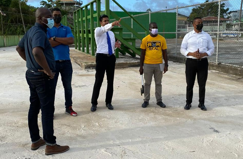 Minister of Culture, Youth and Sport, Charles Ramson Jr (centre) makes a suggestion to GABA officials during their walkthrough of the Gymnasium basketball court project on Mandela Avenue.