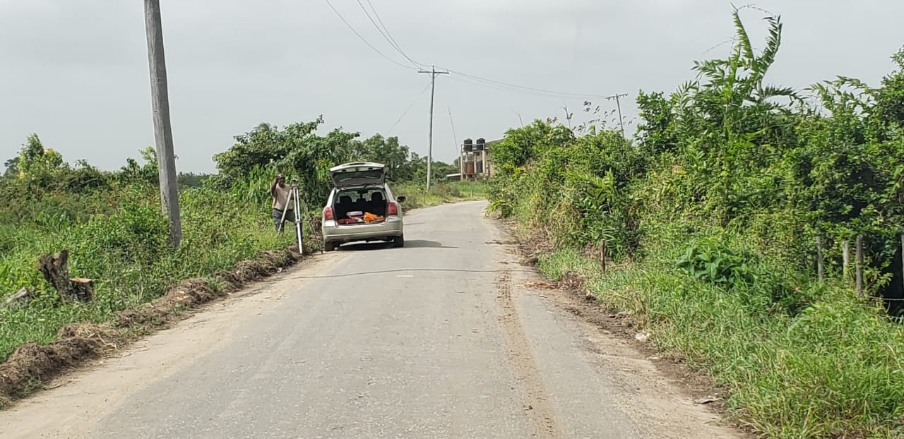 A worker surveying sections of Mahaicony Branch
Road, East Coast Demerara