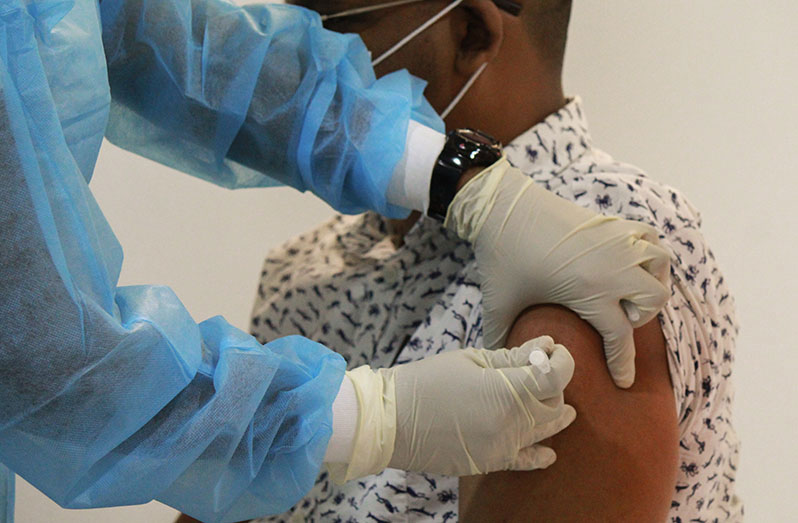 A dose of the Oxford-AstraZeneca vaccine being administered to Dr. Dave Persaud recently, at the National Infectious Diseases Hospital, Liliendaal, Greater Georgetown (Vishani Ragobeer photo)