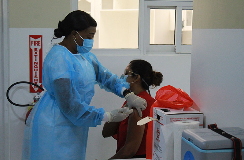 A health worker being vaccinated with an Oxford-AstraZeneca vaccine at the National Infectious Disease Hospital, Liliendaal Georgetown