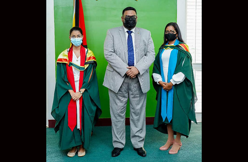 UG Graduation: President, Dr Irfaan Ali with valedictorians Deepa Odit, 24, (left) from the Turkeyen Campus, who graduated with a Bachelor of Science Degree (Pharmacy) and attained a GPA of 3.9 and Savitree Budram, 36, from the Tain Campus, who graduated with a Bachelor of Education (Administration) and achieved a GPA of 4.0 (Office of the President photo)