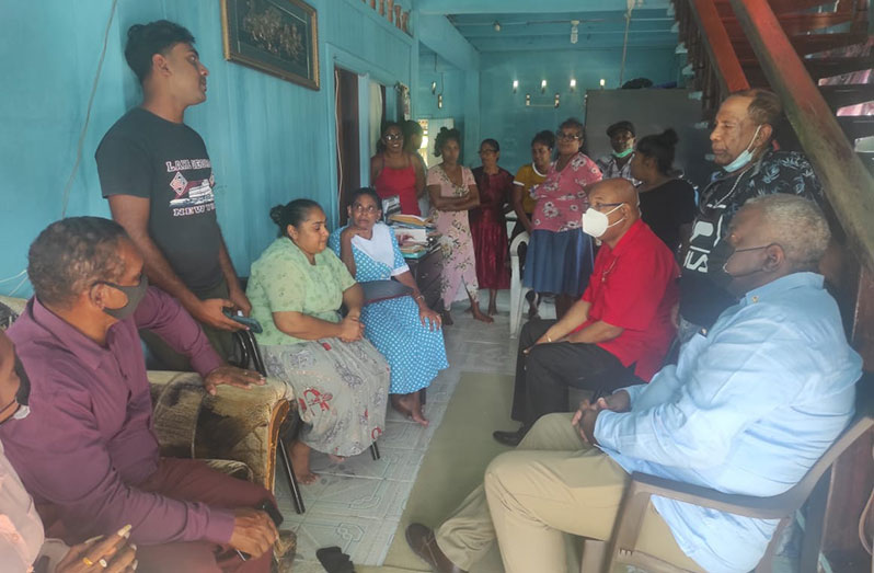 Prime Minister, Brigadier (ret'd) Mark Phillips, and Public Works Minister, Juan Edghill, interacting with the Sukhu family on Wednesday (Office of the Prime Minister photo)