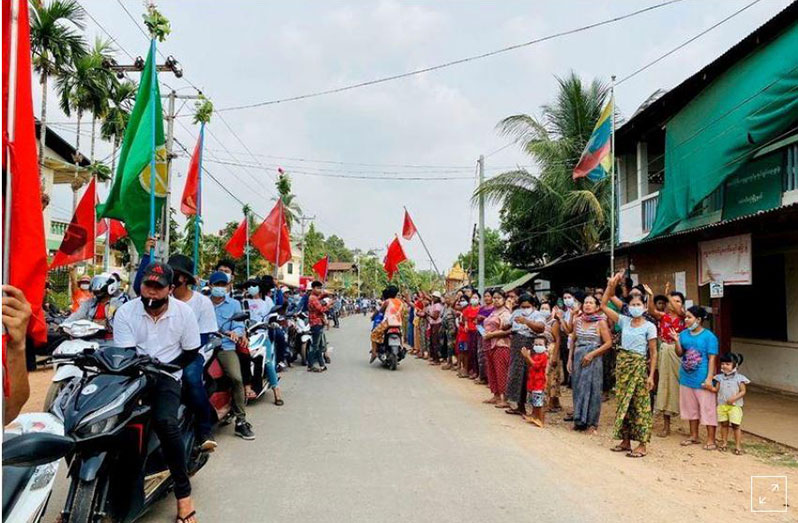 Demonstrators hold flags as they sit on motorcycles during a protest in Launglone, Dawei district, Myanmar March 26, 2021 (Dawei Watch via REUTERS)