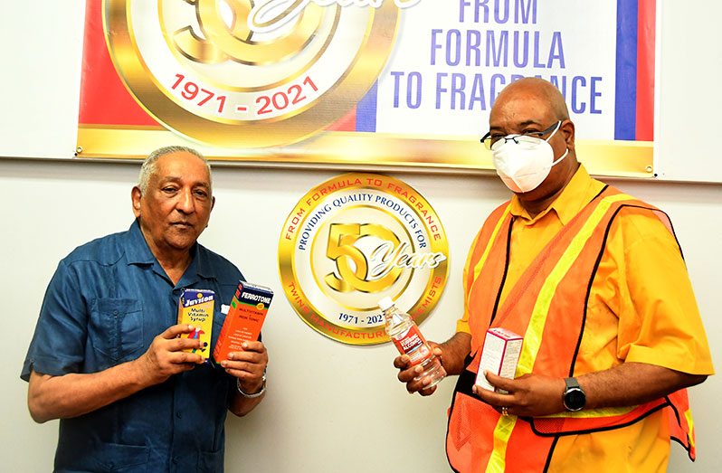 Managing Director of Twins Manufacturing Chemists, Shaheed Mohammed Ferouse, handing over some of the products to Public Works Minister, Juan Edghill