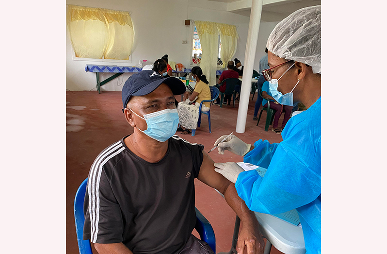 An elder taking the vaccine during a vaccination drive