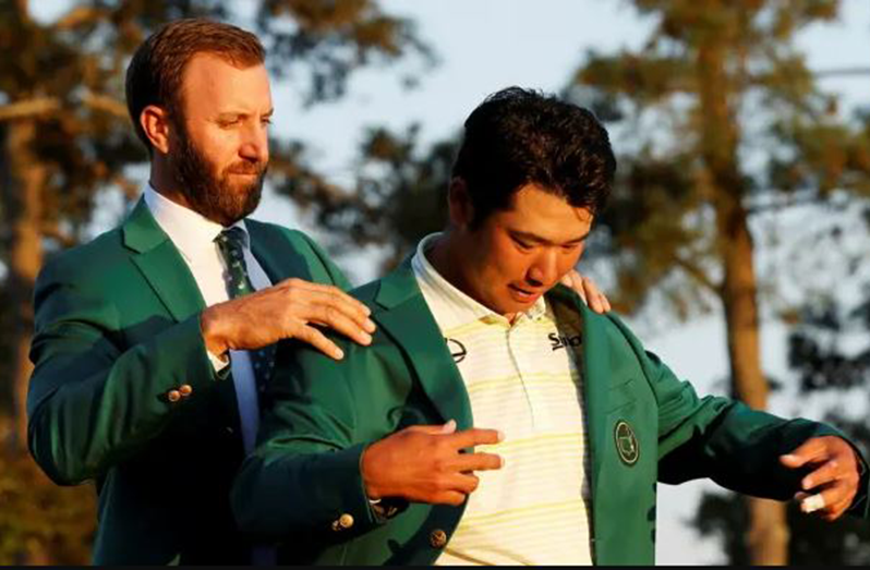 Hideki Matsuyama is presented with the winner’s green jacket by last year’s US Masters champion Dustin Johnson © Reuters