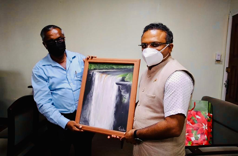 High Commissioner of India, Dr. K.J. Srinivasa, offers a token of appreciation to NAREI’s CEO Jagnarine Singh, during the visit