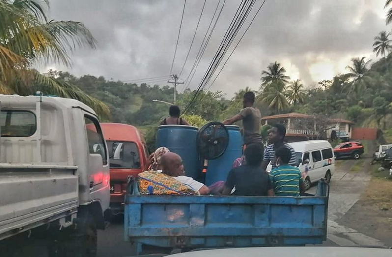 Residents of communities in northeast St Vincent, around the La Soufriere area, on trucks and at the side of the road waiting for rides to safer areas on Thursday evening (Search Light St. Vincent photo)