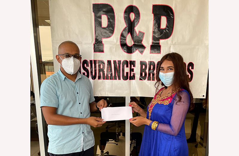 P&P Insurance Brokers and Consultants Ltd’s Ms Urmila Shamsundar hands  over sponsorship funds to GSSF treasurer Mr Ray Beharry.
