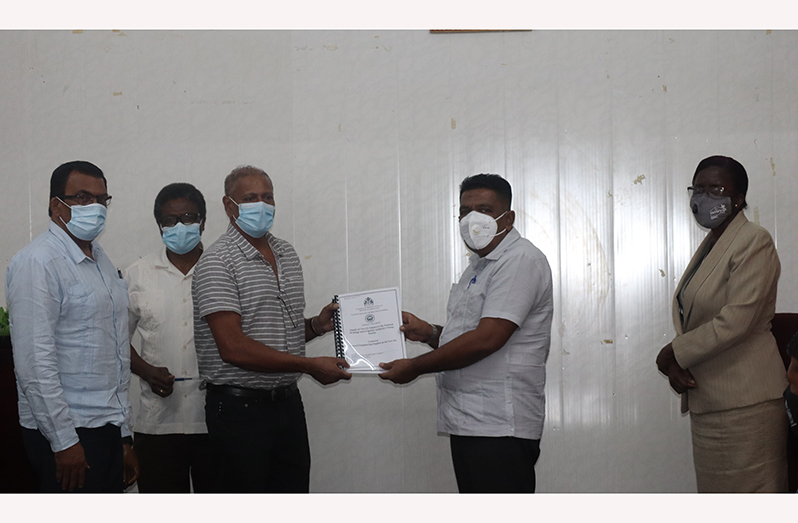 Agriculture Minister, Zulfikar Mustapha, (second right) hands over a contract document to one of the contractors who will be executing works for the NDIA, as Agriculture Ministry officials look on