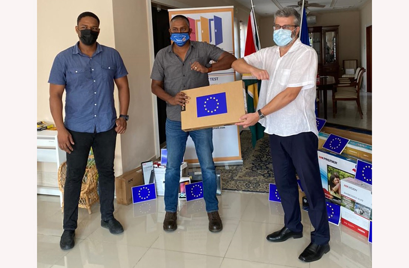 EU Ambassador, Fernando Ponz Cantó, hands over the equipment to outgoing Rotary Demerara President, Bhageshwar Murli in the presence of Carey Griffith