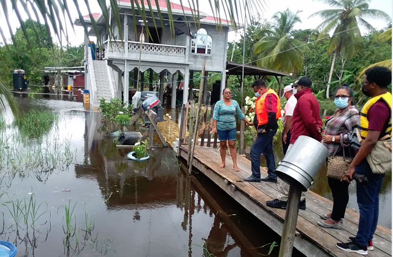 Regional authorities meet with this flood-affected resident