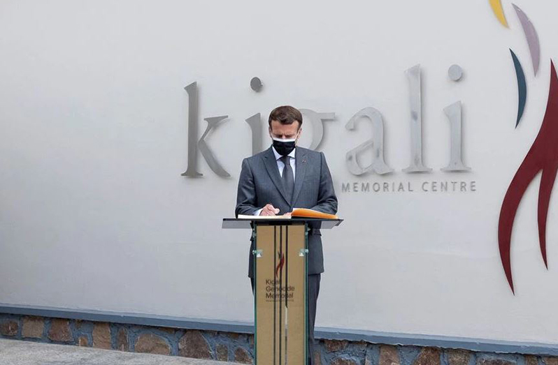 French President Emmanuel Macron signing a memorial book on Thursday after laying a wreath on a mass grave containing the remains of the 1994 Rwandan genocide victims at the Kigali Genocide Memorial Center at Gisozi in Kigali, Rwanda (REUTERS/Jean Bizimana)