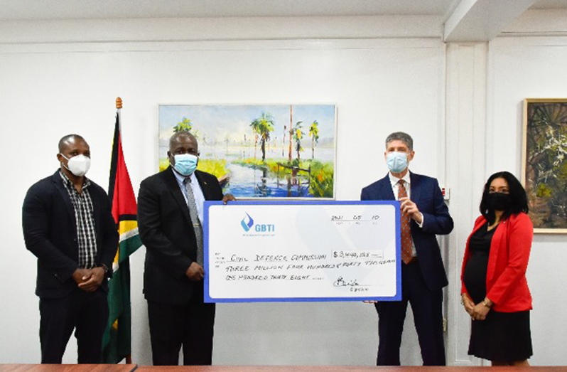 Prime Minister Mark Phillips receives the cheque from GBTI Chief Executive Officer (ag), James Foster, as Public Relations/Marketing Manager of GBTI, Pamela Binda-Pryce and Deputy Director-General of the CDC, Major Loring Benons look on